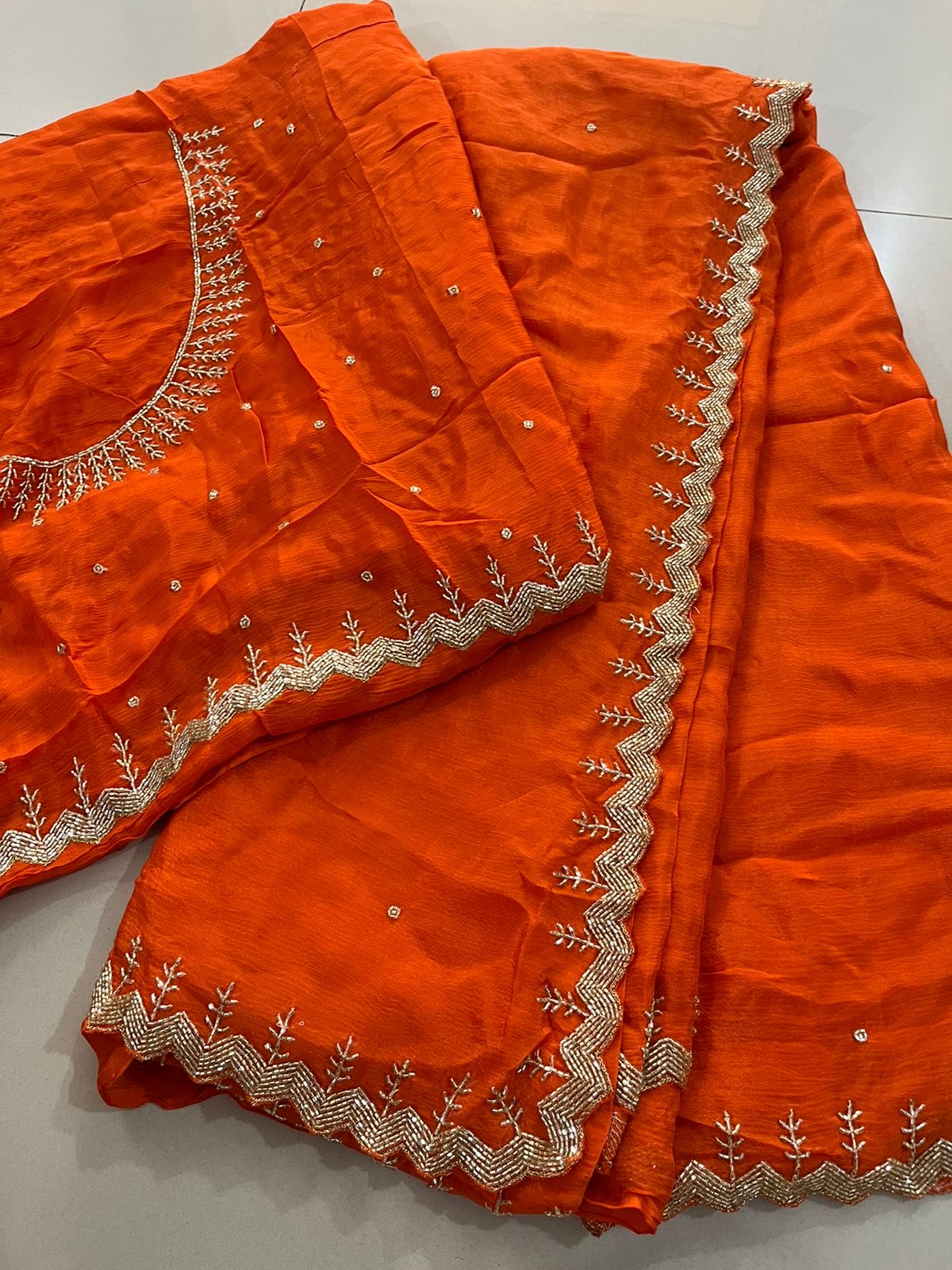 "Yashvi" Beautiful orange Pure Chinnon handwork saree